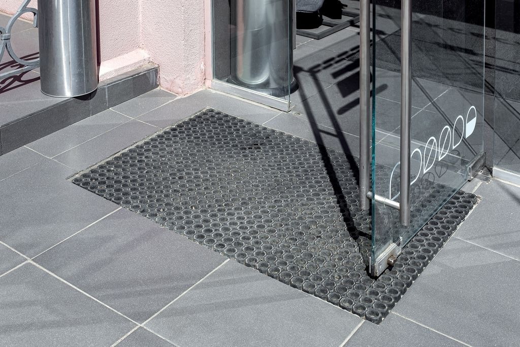 Tapis d entree noir encastre a fleur dans carrelage gris anthracite a Bordeaux, pose technique par MC Carreleur.