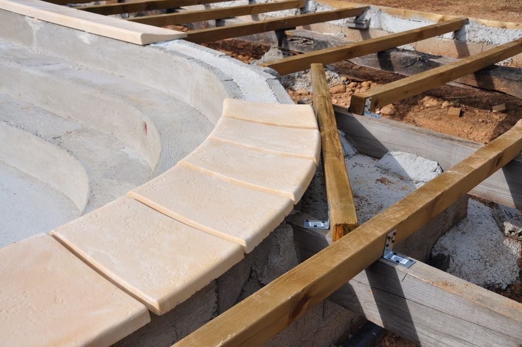 Chantier margelles pierre et lambourdes bois autour d une piscine a Saint-Andre-de-Cubzac par MC Carreleur.